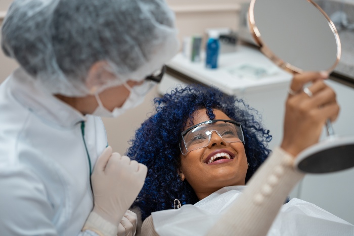 Female happy with the results of cosmetic dentistry veneers in Kalamazoo, MI