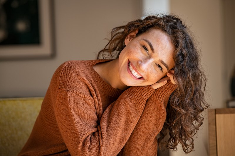 A smiling middle-aged woman rejuvenated smile with restorative dental care in Kalamazoo, MI