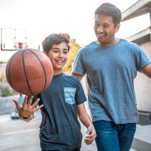 father and son smiling with basketball