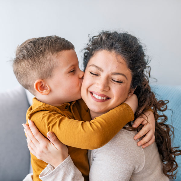 Boy hugging his mother after she completed general dental treatment in Kalamazoo, MI