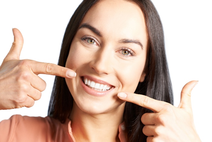 Woman showing after results of cosmetic dentistry treatments in Kalamazoo, MI
